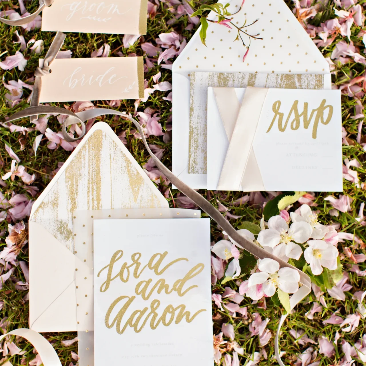 A wedding invitation suite with gold lettering and envelope liners.